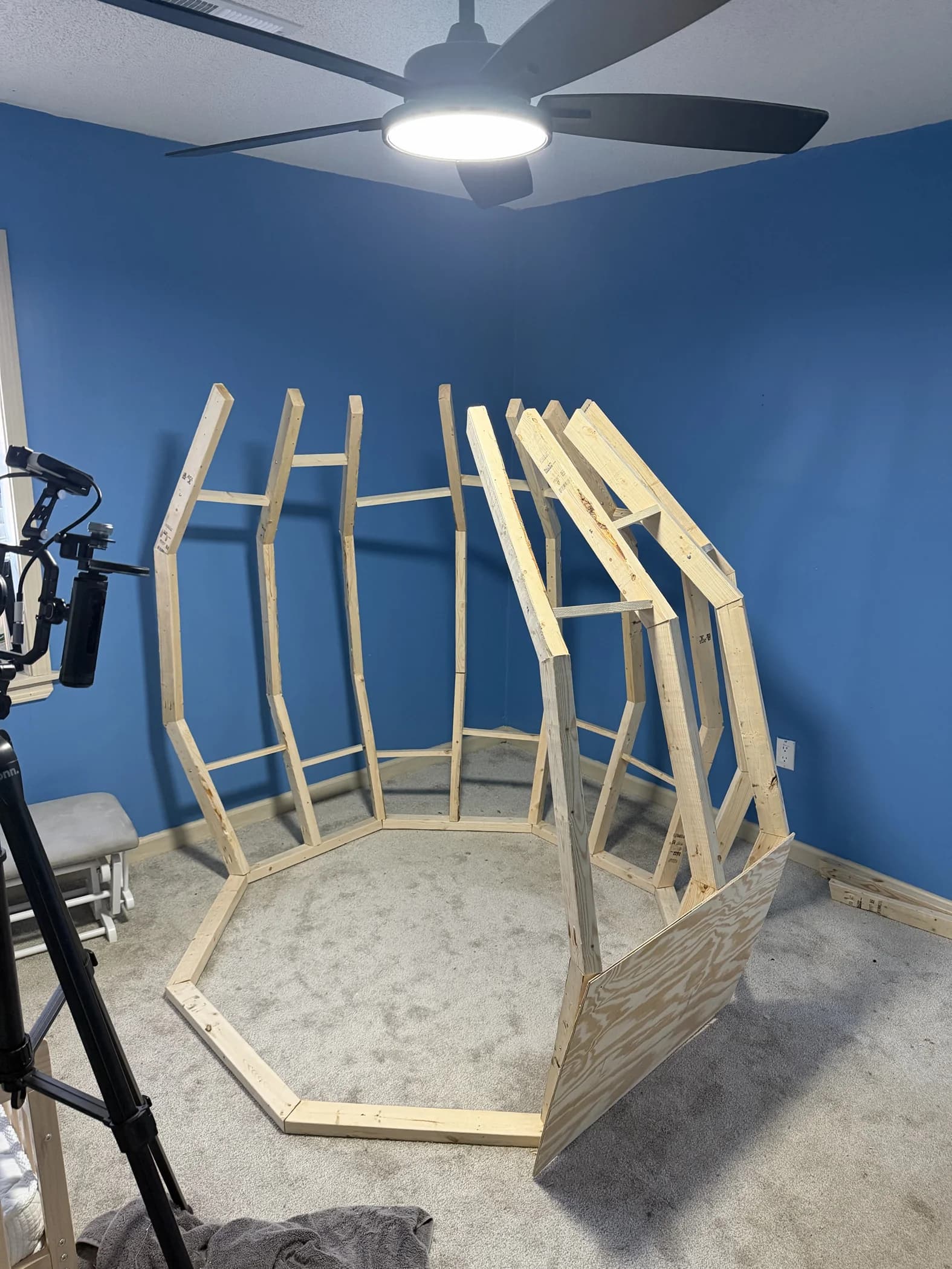 The unfinished wooden pineapple frame taking shape in Mykah’s blue bedroom